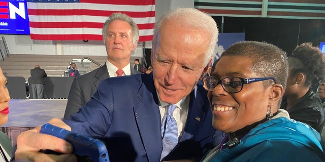 Then-former Vice President Joe Biden takes a selfie with a supporter in Columbia, South Carolina, after winning the state's Democratic presidential primary in a landslide, on Feb. 29, 2020.