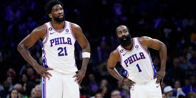 Philadelphia 76ers' Joel Embiid, left, and James Harden watch a free-throw attempt during the second half of an NBA basketball game against the Toronto Raptors, Monday, Dec. 19, 2022, in Philadelphia. 