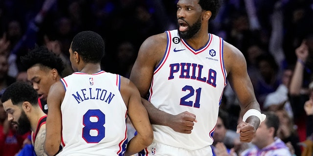 Philadelphia 76ers' Joel Embiid, right, and De'Anthony Melton celebrate after an NBA basketball game against the Toronto Raptors, Monday, Dec. 19, 2022, in Philadelphia. 