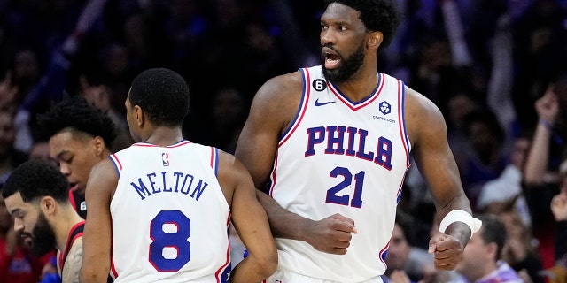 Philadelphia 76ers' Joel Embiid, right, and De'Anthony Melton celebrate after an NBA basketball game against the Toronto Raptors, Monday, Dec. 19, 2022, in Philadelphia. 