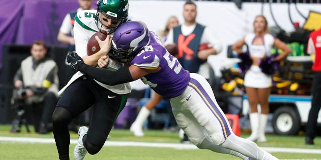 New York Jets quarterback Mike White (5) is tackled by Minnesota Vikings linebacker Jordan Hicks (58) during the second half of an NFL football game, Sunday, Dec. 4, 2022, in Minneapolis. 