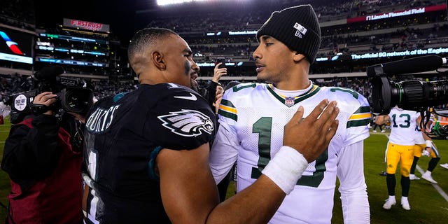 Philadelphia Eagles quarterback Jalen Hurts, #1, talks with Green Bay Packers quarterback Jordan Love, #10, following an NFL football game, Sunday, Nov. 27, 2022, in Philadelphia. 