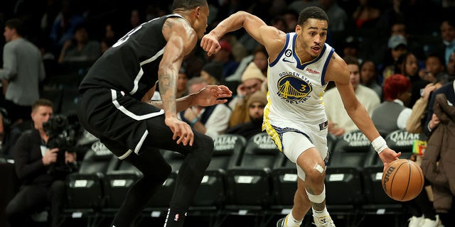 Jordan Poole (3) of the Golden State Warriors drives to the basket against Nic Claxton (33) of the Brooklyn Nets during the second half of a game at Barclays Center Dec. 21, 2022, in the Brooklyn borough of New York City.