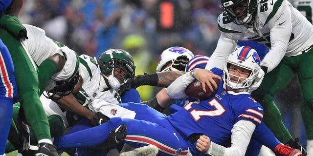 Buffalo Bills quarterback Josh Allen scores a touchdown against the New York Jets during the second half, Sunday, Dec. 11, 2022, in Orchard Park, New York.