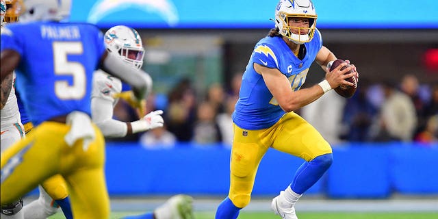 Dec 11, 2022; Inglewood, California, USA; Los Angeles Chargers quarterback Justin Herbert (10) moves out to pass against the Miami Dolphins during the first half at SoFi Stadium.