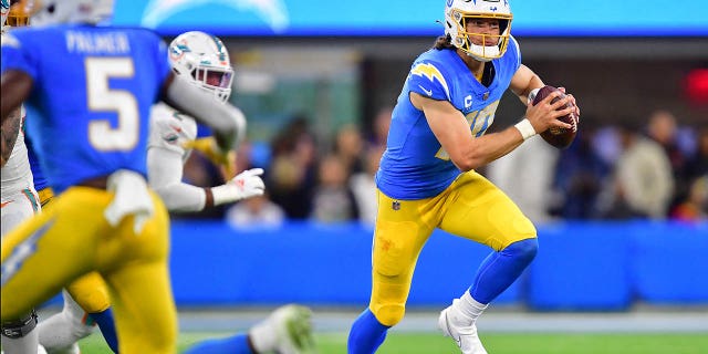 Dec 11, 2022; Inglewood, California, USA; Los Angeles Chargers quarterback Justin Herbert (10) moves out to pass against the Miami Dolphins during the first half at SoFi Stadium.