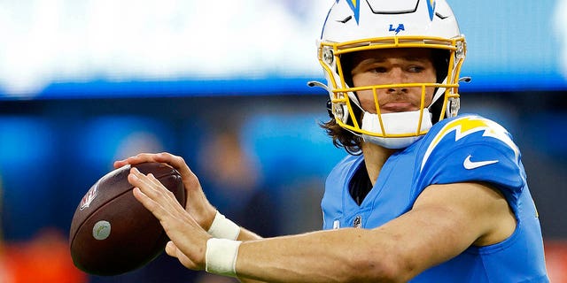 Justin Herbert #10 of the Los Angeles Chargers warms up during a game against the Miami Dolphins at SoFi Stadium on December 11, 2022 in Inglewood, California.