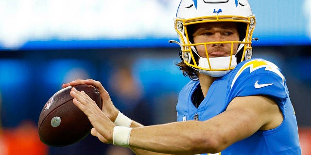 Justin Herbert #10 of the Los Angeles Chargers warms up during a game against the Miami Dolphins at SoFi Stadium on December 11, 2022 in Inglewood, California.