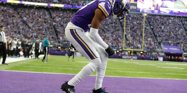 Minnesota Vikings wide receiver Justin Jefferson celebrates after catching a 10-yard touchdown pass during the second half of an NFL football game against the New York Jets, Sunday, Dec. 4, 2022, in Minneapolis. 