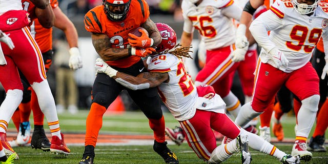 Bengals running back Samaje Perine is tackled by Kansas City Chiefs safety Justin Reid in Cincinnati, Sunday, Dec. 4, 2022.