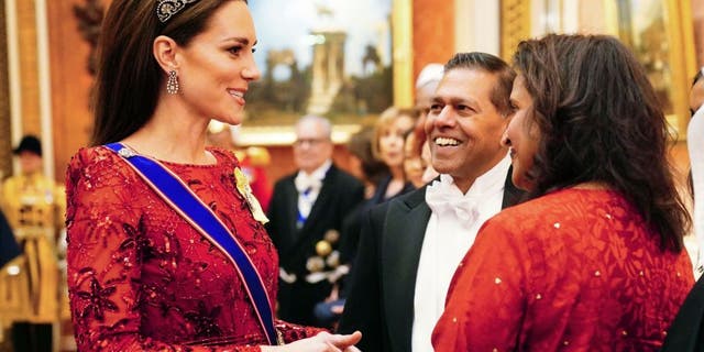 Kate Middleton speaks to guests during the reception. She wore a tiara – originally a necklace given to the queen mother by King George VI. The queen mother had it turned into a tiara, according to a royal expert.