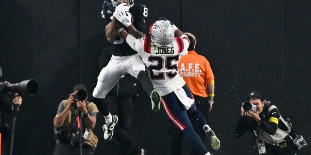 Las Vegas Raiders wide receiver Keelan Cole, #84, catches a touchdown pass against New England Patriots cornerback Marcus Jones, #25, during the second half of an NFL football game between the New England Patriots and Las Vegas Raiders, Sunday, Dec. 18, 2022, in Las Vegas. 