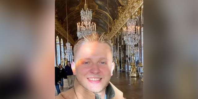 Ken DeLand smiling in a photo of his Instagram story from Versailles. 