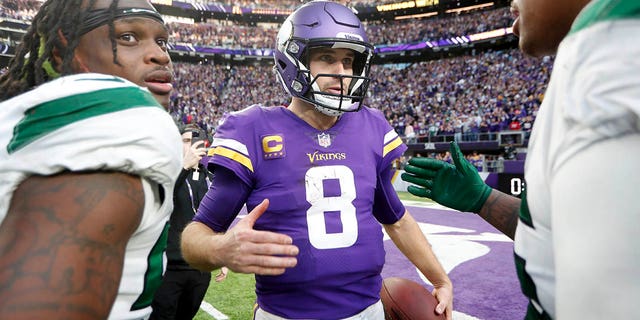 Minnesota Vikings quarterback Kirk Cousins, #8, talks to New York Jets players after an NFL football game, Sunday, December 4, 2022, in Minneapolis. 