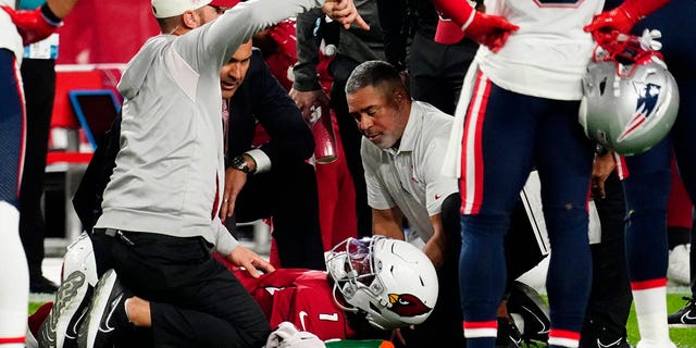 Arizona Cardinals quarterback Kyler Murray, #1, lies on the ground after an injury during the first half of an NFL football game against the New England Patriots, Monday, Dec. 12, 2022, in Glendale, Arizona.