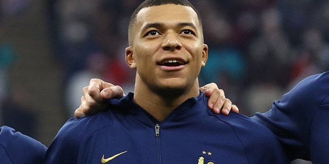 France's Kylian Mbappe lines up during the national anthems before the match.