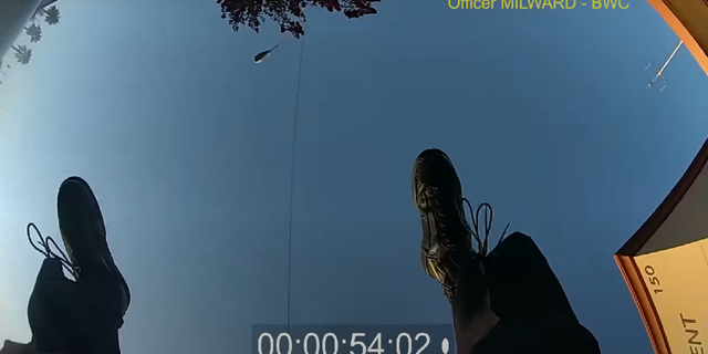 La Habra Police Officer Mark Milward is seen falling to the ground after being shot.