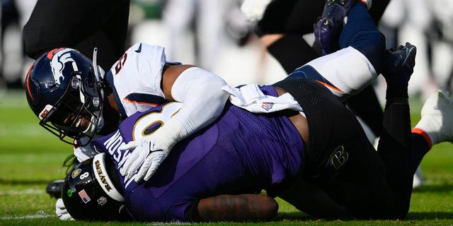 Ravens quarterback Lamar Jackson is sacked by Denver Broncos linebacker Jonathon Cooper, Sunday, Dec. 4, 2022, in Baltimore.