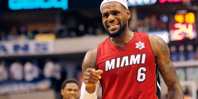 Miami Heat forward LeBron James reacts against the Dallas Mavericks during the second half of their NBA basketball game in Dallas, Texas, December 25, 2011.