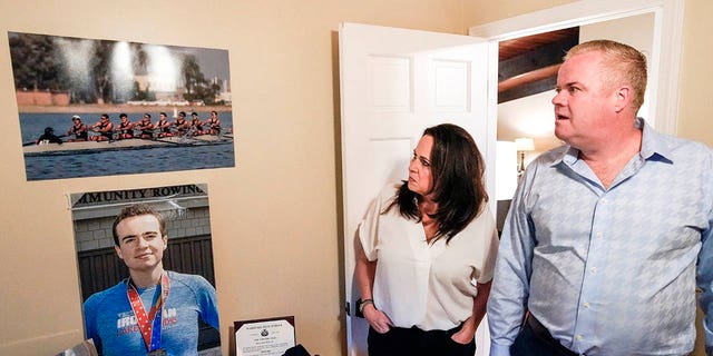 Brenda and Brian Lilly look at photos of their son Brian Lilly Jr. in their Easton, Conn. home, Thursday, Oct. 13, 2022. Brian Lilly Jr., 19, who committed suicide on Jan. 4, 2021, was a rower at University of California San Diego.