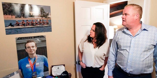 Brenda and Brian Lilly look at photos of their son Brian Lilly Jr. in their Easton, Conn. home, Thursday, Oct. 13, 2022. Brian Lilly Jr., 19, who committed suicide on Jan. 4, 2021, was a rower at University of California San Diego.