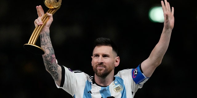 Argentina's Lionel Messi waves after receiving the Golden Ball award for best player of the tournament at the end of the World Cup final soccer match between Argentina and France at Lusail Stadium in Lusail, Qatar, Sunday, Dec. 18, 2022.
