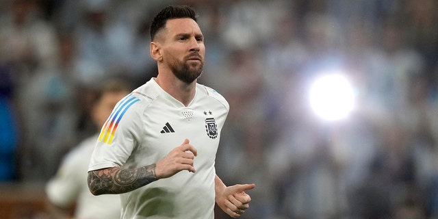 Argentina's Lionel Messi warms up for the World Cup final soccer match against France at the Lusail Stadium in Lusail, Qatar, Sunday, Dec. 18, 2022.