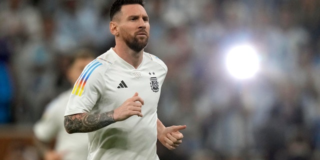 Argentina's Lionel Messi warms up for the World Cup final soccer match against France at the Lusail Stadium in Lusail, Qatar, Sunday, Dec. 18, 2022.