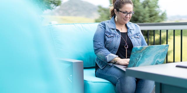303 Creative owner Lorie Smith works on her laptop.