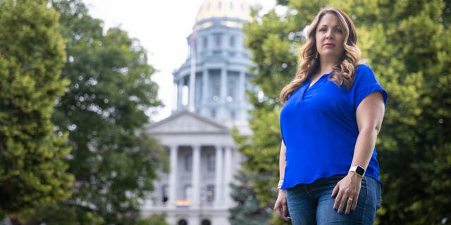 303 Creative owner Lorie Smith stands in front of the Colorado State Capitol.