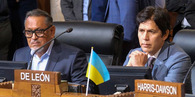 Los Angeles City Council members Gil Cedillo, left, and Kevin de Leon sit in chamber before starting the City Council meeting on Oct. 11, 2022, in Los Angeles.
