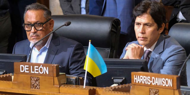 Los Angeles City Council members Gil Cedillo, left, and Kevin de Leon sit in chamber before starting the City Council meeting on Oct. 11, 2022, in Los Angeles.