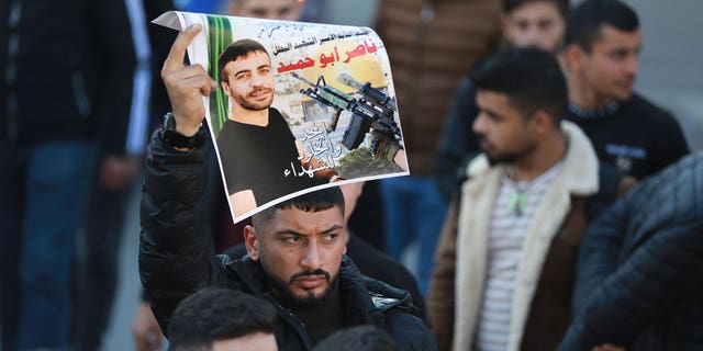 Palestinians gather to stage a demonstration after Nasser Abu Hamid, 50, died in an Israeli prison in Ramallah, West Bank, on Dec. 20, 2022. Nasser Abu Hamid was suffering from lung cancer while serving seven life sentences.