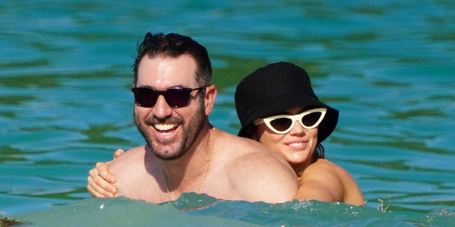Kate Upton holds on tightly to her husband, Justin Verlander, in the St. Barts water.