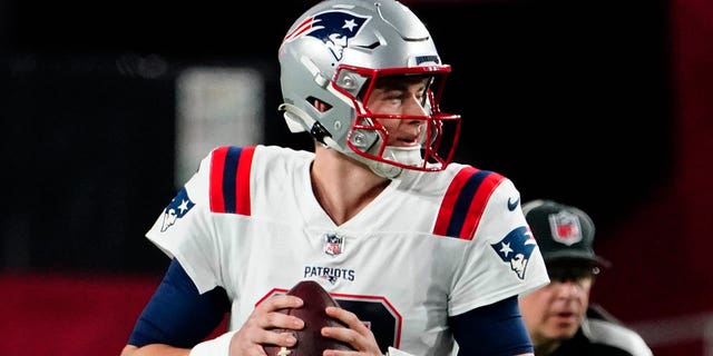 New England Patriots quarterback Mac Jones, #10, looks to pass against the Arizona Cardinals during the first half of an NFL football game, Monday, Dec. 12, 2022, in Glendale, Arizona.