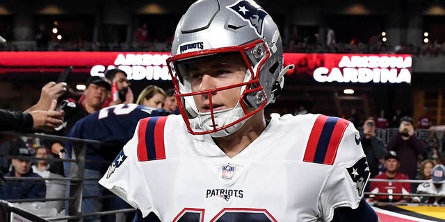 Mac Jones, #10 of the New England Patriots, takes the field with his teammates prior to the game against the Arizona Cardinals at State Farm Stadium on Dec. 12, 2022 in Glendale, Arizona.