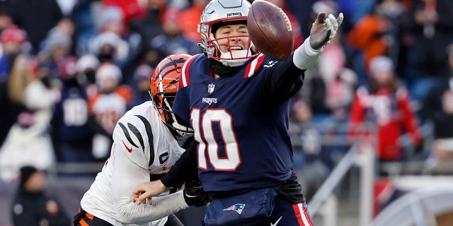 Vonn Bell #24 of the Cincinnati Bengals pressures Mac Jones #10 of the New England Patriots as he attempts a pass during the fourth quarter at Gillette Stadium on December 24, 2022 in Foxborough, Massachusetts.