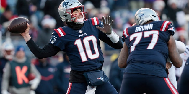 Mac Jones #10 of the New England Patriots attempts a pass during the third quarter against the Cincinnati Bengals at Gillette Stadium on December 24, 2022 in Foxborough, Massachusetts.