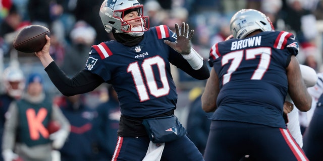 Mac Jones #10 of the New England Patriots attempts a pass during the third quarter against the Cincinnati Bengals at Gillette Stadium on December 24, 2022 in Foxborough, Massachusetts.