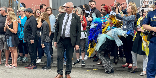 Some of the colorful crowd of well-wishers hoping to catch a glimpse of French President Emmanuel Macron during his diplomatic tour of the French Quarter in New Orleans, December 2022.