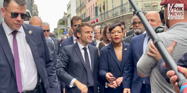 French President Emmanuel Macron pictured with controversial New Orleans mayor LaToya Cantrell in the French Quarter during a diplomatic tour, December 2022.