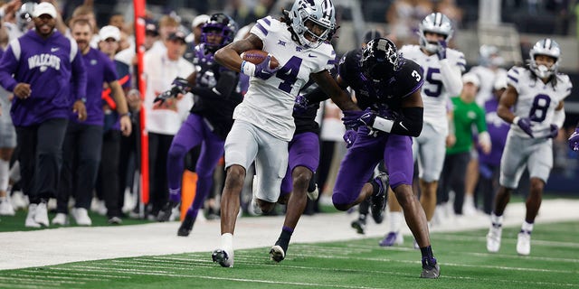 Wide receiver Malik Knowles (4) of the Kansas State Wildcats is tackled by safety Mark Perry (3) of the TCU Horned Frogs after making a catch in the second quarter at AT and T Stadium Dec. 3, 2022, in Arlington, Texas.