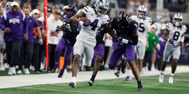 Wide receiver Malik Knowles (4) of the Kansas State Wildcats is tackled by safety Mark Perry (3) of the TCU Horned Frogs after making a catch in the second quarter at AT and T Stadium Dec. 3, 2022, in Arlington, Texas.