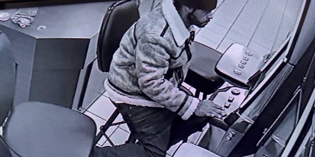 Ax-wielding Georgian smashes lottery machine, steals cash from convenience store 2 The suspect was seen playing on the machine before the attack.