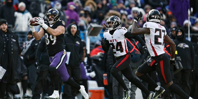 BALTIMORE, MARYLAND - DECEMBER 24: Mark Andrews #89 of the Baltimore Ravens completes a pass against A.J. Terrell #24 of the Atlanta Falcons during an NFL football game between the Baltimore Ravens and the Atlanta Falcons at M&T Bank Stadium on December 24, 2022, in Baltimore, Maryland.