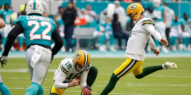 Green Bay Packers place kicker Mason Crosby (2) kicks a field goal, held by Green Bay Packers punter Pat O'Donnell (16) during the first half of an NFL football game, Sunday, Dec. 25, 2022, in Miami Gardens, Fla. 