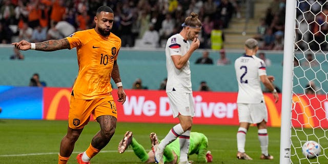 Memphis Depay celebrates after scoring the opening goal of his team during the World Cup round of 16 match between the Netherlands and the United States, at the Khalifa International Stadium in Doha, Qatar, Saturday, Dec. 3, 2022.