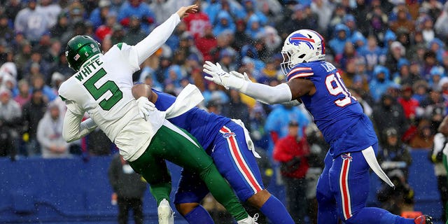 Mike White of the New York Jets is hit during the first half against the Buffalo Bills at Highmark Stadium on Dec. 11, 2022, in Orchard Park, New York.