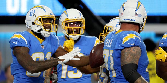 Los Angeles Chargers' Mike Williams is congratulated by teammates after scoring a touchdown in the first quarter of a game at SoFi Stadium in Inglewood, California on December 11, 2022.