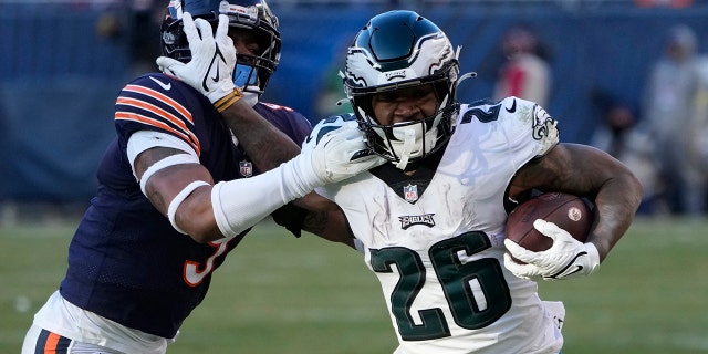 Philadelphia Eagles' Miles Sanders, right, tries to get past Chicago Bears' Jaquan Brisker during the second half of a game on December 18, 2022 in Chicago.